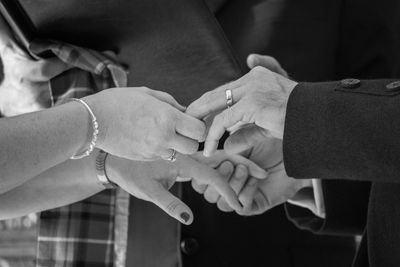 Midsection of couple holding hands