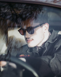 Portrait of young man in car