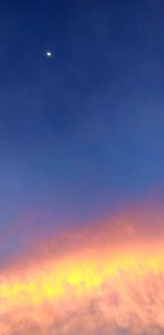 Low angle view of moon at sunset