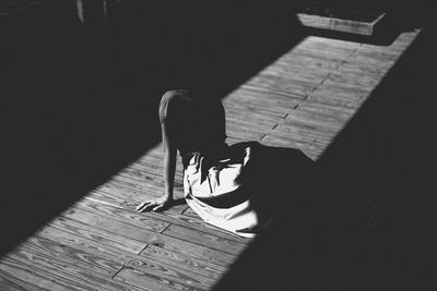 Woman sitting on hardwood floor