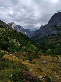 Scenic view of mountains against cloudy sky