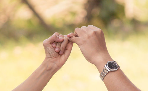 Midsection of couple holding hands