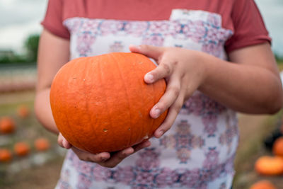 Close-up of hand holding pumpkin during autumn