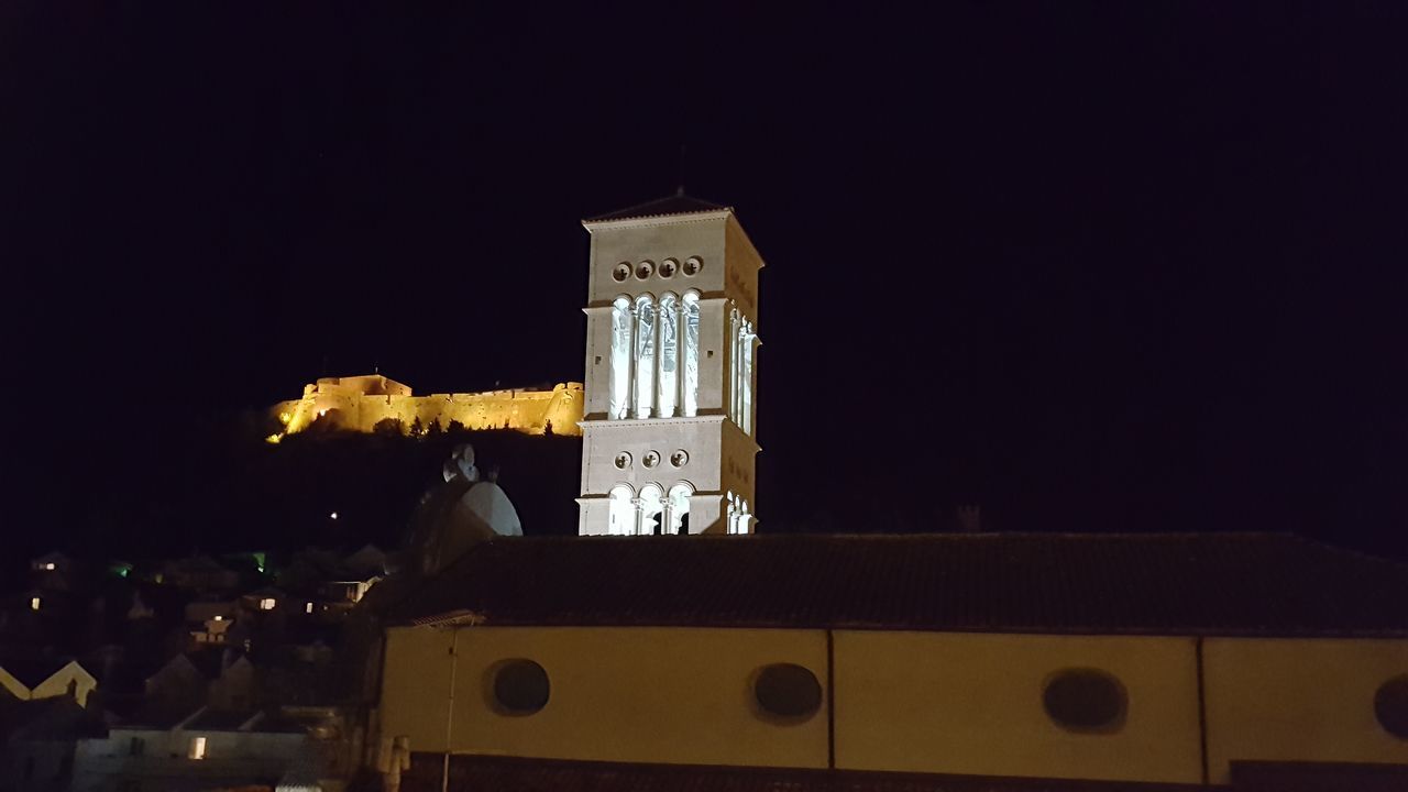 LOW ANGLE VIEW OF ILLUMINATED BUILDING AGAINST SKY