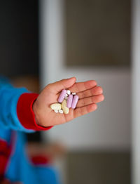 Close-up of hand holding pills