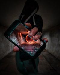 Man showing wire wool on smart phone screen in tunnel