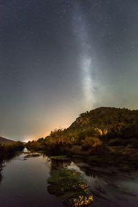 Scenic view of lake against star field at night