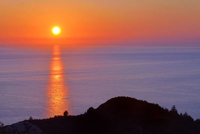 Scenic view of sea against romantic sky at sunset