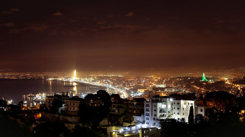 High angle view of illuminated city buildings at night