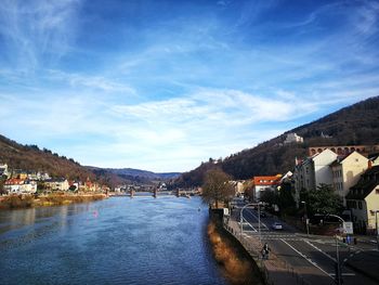 River amidst buildings in town against sky