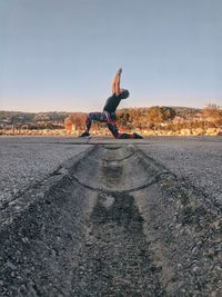 Girl doing yoga outdoors.