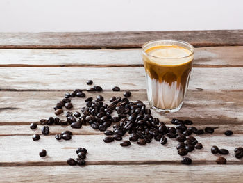 High angle view of coffee beans in glass on table