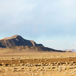 Scenic view of arid landscape against sky