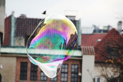 Close-up of bubbles against buildings in city