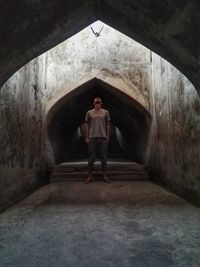 Rear view of man standing in tunnel