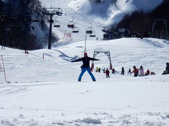 People skiing on snow covered field