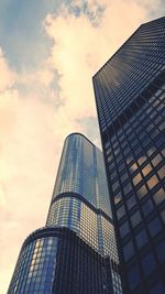 Low angle view of modern building against cloudy sky