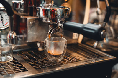 Cropped hand pouring coffee