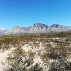 Scenic view of mountains against clear blue sky