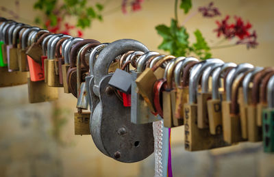 Close-up of padlocks hanging on railing