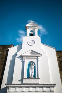 Low angle view of bell tower against sky