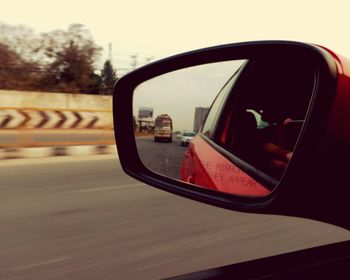 Close-up of cropped mirror reflecting on side-view mirror