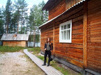 Woman standing outside house