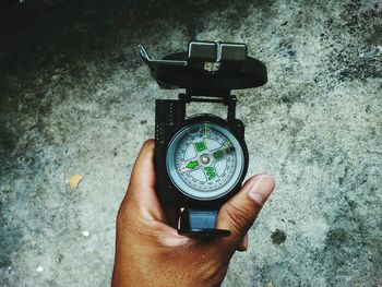 High angle view of hand holding camera