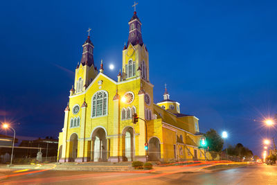 Illuminated building against sky at night