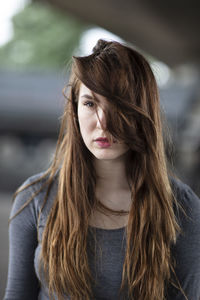 Close-up of beautiful young woman with tousled hair