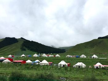 Scenic view of green landscape and mountains against sky