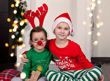 Portrait of cute girl playing with christmas decoration