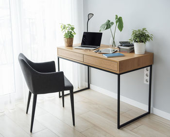 Office workplace with laptop on wooden table