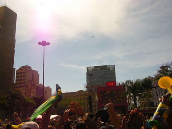 Group of people on street against buildings in city