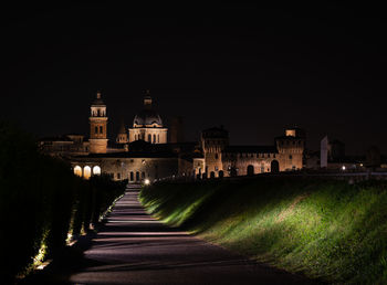 Illuminated buildings against sky at night