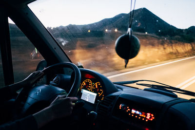 Close-up of hand on car windshield