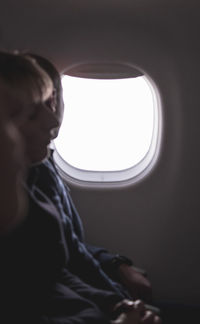 Man looking through airplane window