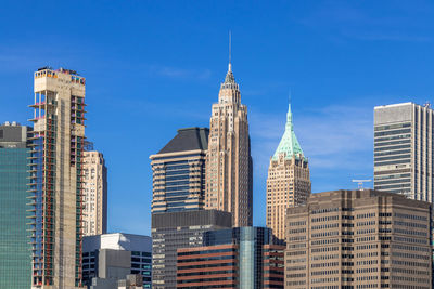 Low angle view of buildings against blue sky