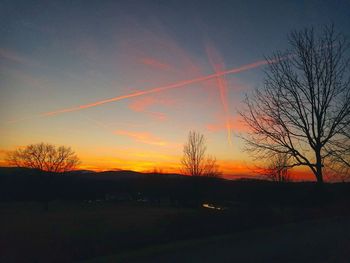 Silhouette trees against sky during sunset