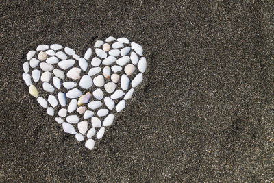 High angle view of heart shape on sand