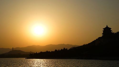 Scenic view of silhouette mountains against sky during sunset