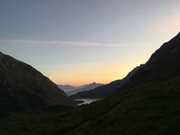 Scenic view of silhouette mountains against sky during sunset