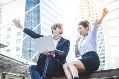 Women sitting in front of office building