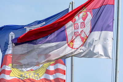 Low angle view of flags against the sky