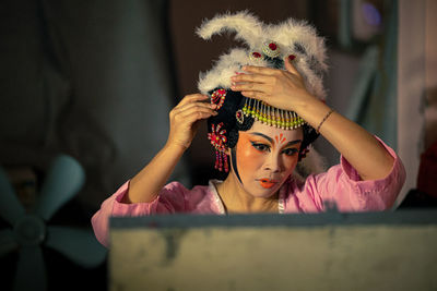 Portrait of young woman looking away at home