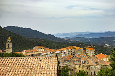 Buildings in town against sky