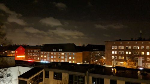 Buildings in city against sky at night