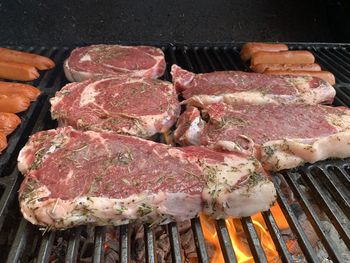 High angle view of meat on barbecue grill