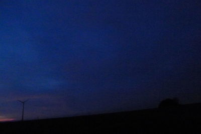 Low angle view of silhouette landscape against sky at night