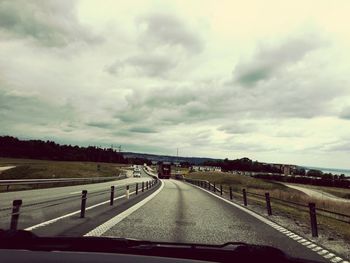 View of road against cloudy sky
